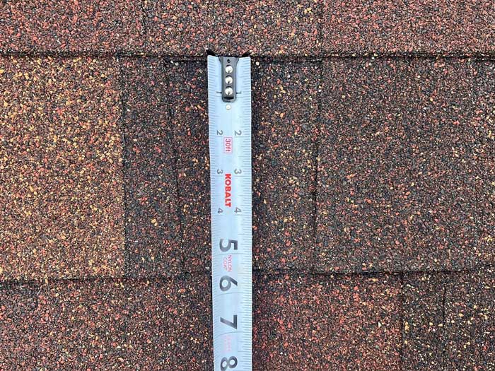 Measuring tape during a huber heights roof inspection